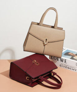 Two stylish leather crossbody tote bags, one in beige and one in burgundy, featuring elegant top handles and gold-tone clasps.
