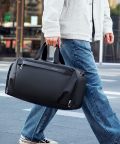 Gym Duffel Bag in Classic Black carried by a man walking outdoors