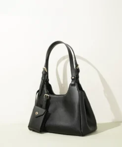 Black convertible leather crossbody bag with adjustable straps, structured silhouette, and small matching pouch with gold hardware.